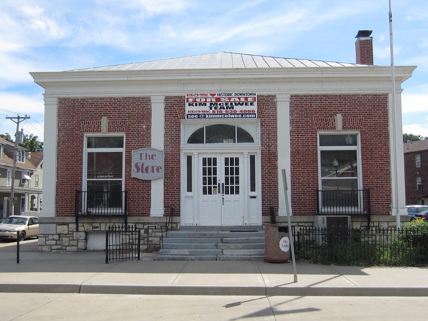 Brick former Carnegie public library building with white columns in downtown Excelsior Springs, Missouri