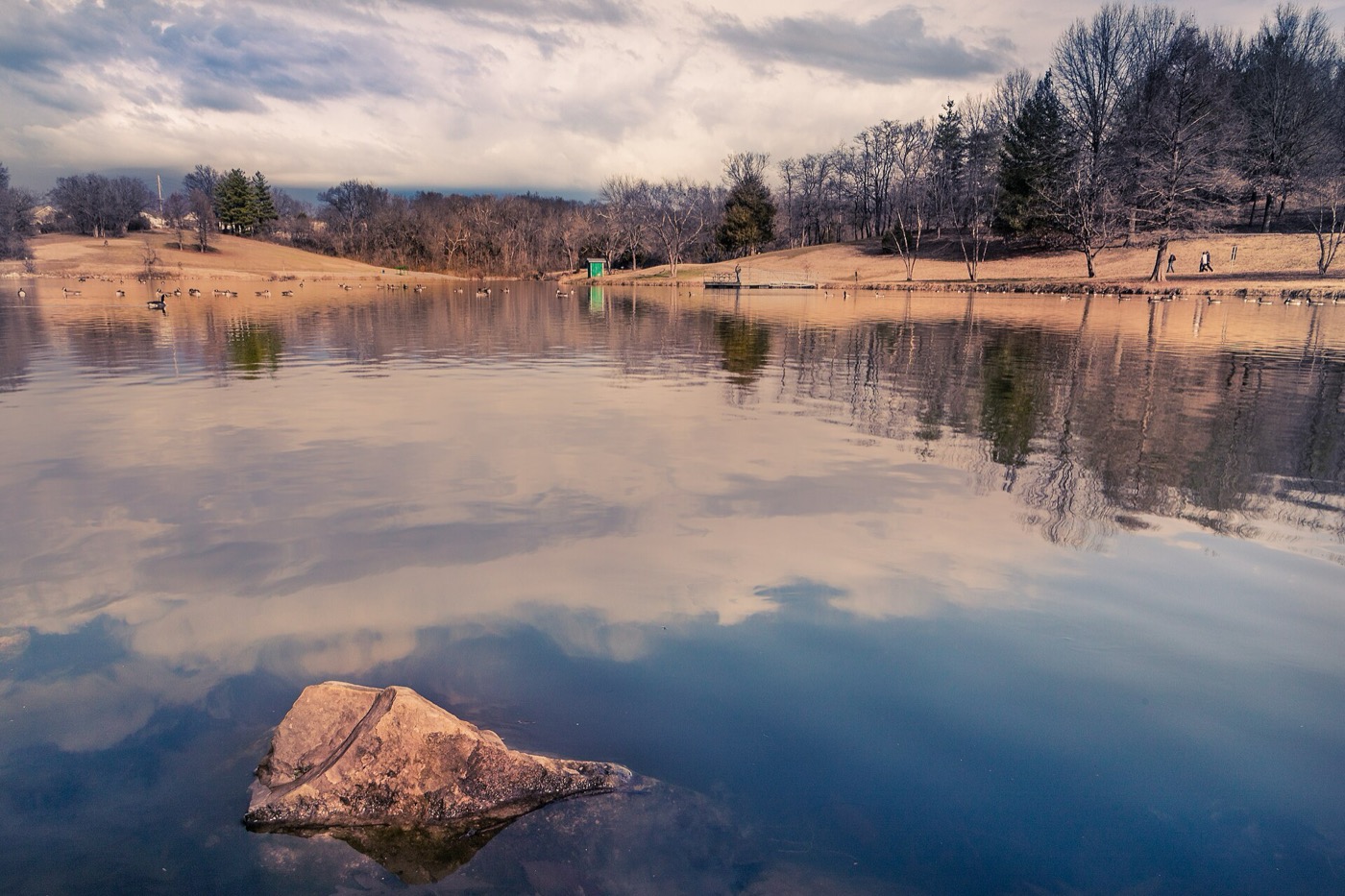 Calm lake with a wooded shoreline at Bee Tree County Park in Oakville, Missouri