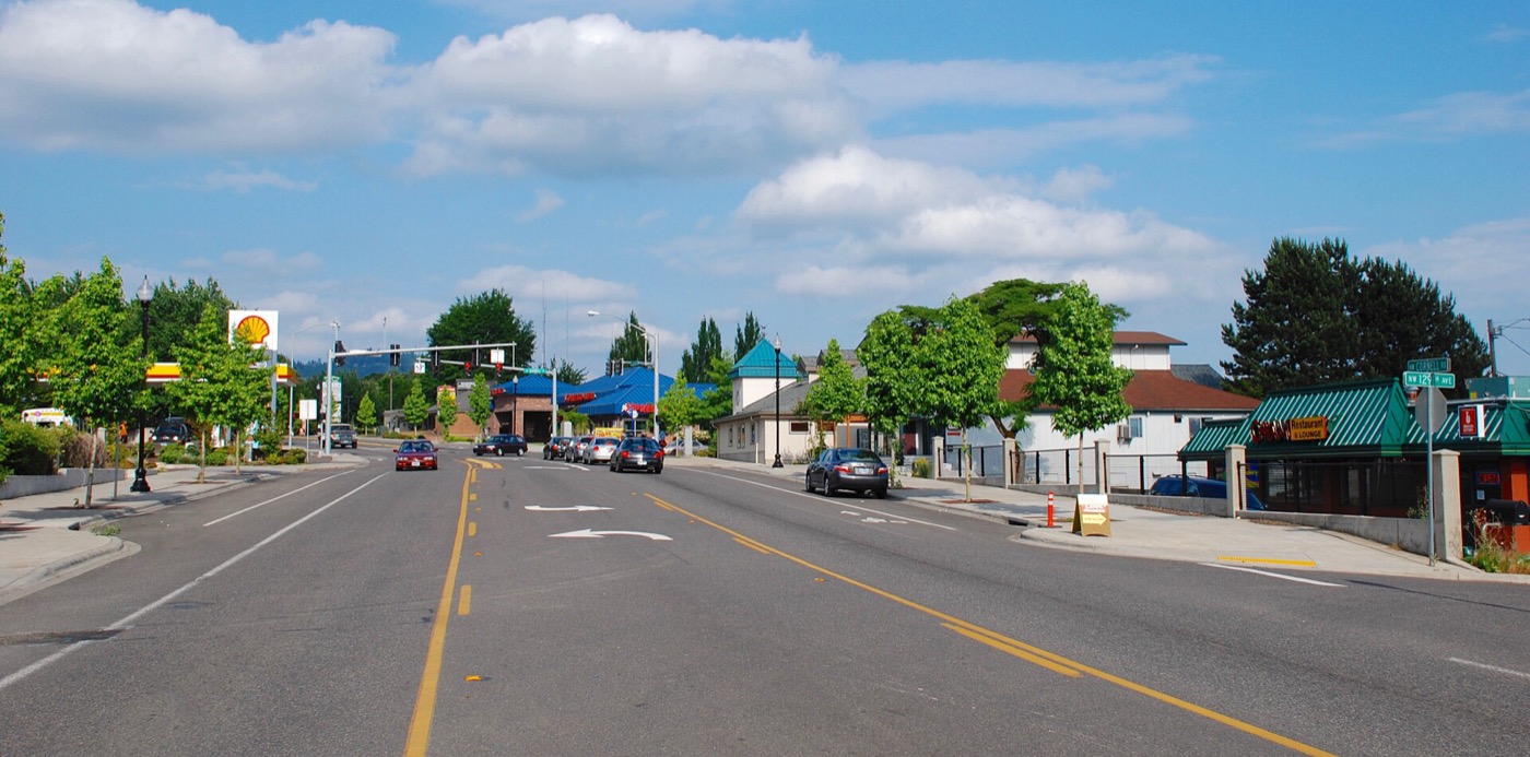 Cornell Road running through the Cedar Mill commercial area with shops and trees