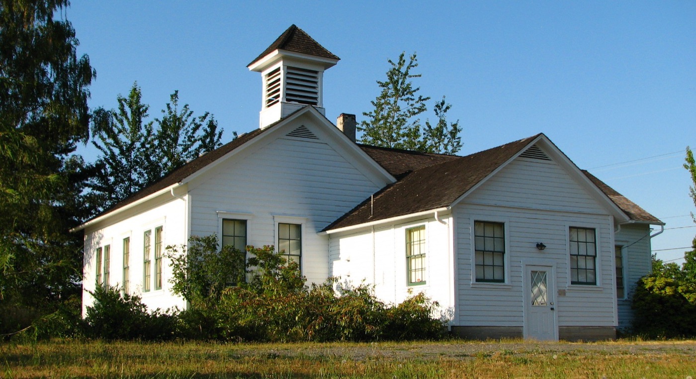 White wooden one-room schoolhouse with a bell tower in Damascus, Oregon
