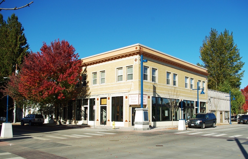 Brick storefronts and a wide sidewalk in Old Town Sherwood, Oregon