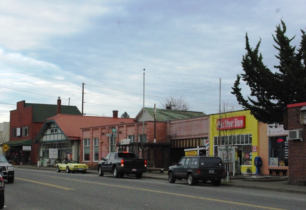 Main Street in downtown Tigard with low commercial buildings and power lines