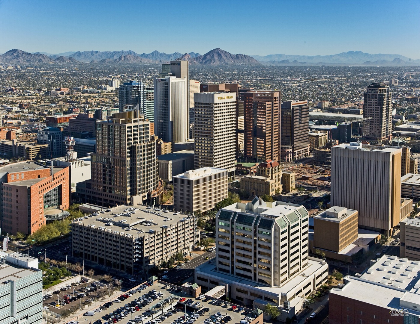 Aerial view of downtown Phoenix high-rises with desert mountains beyond