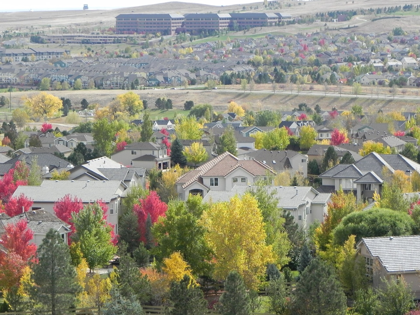 Rooftops of the Rock Creek subdivision in Superior surrounded by colorful autumn trees