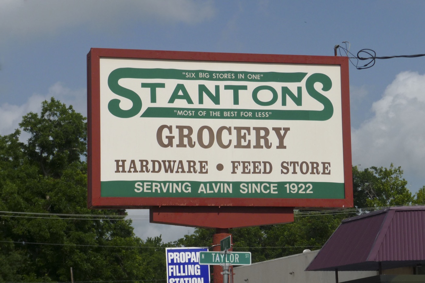 Roadside sign for Stanton's grocery, hardware and feed store, serving Alvin since 1922