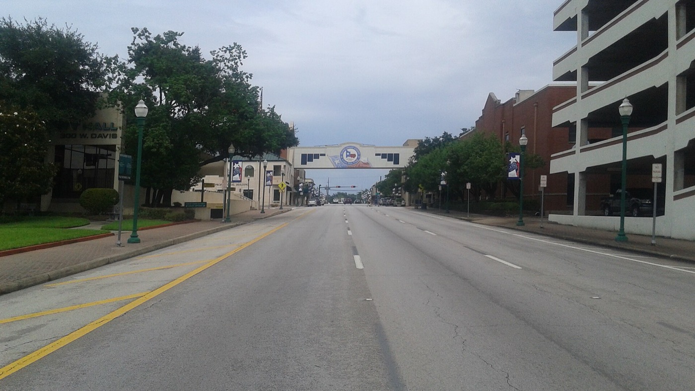 Highway 105 in downtown Conroe with the archway linking the Montgomery County Courthouse and annex
