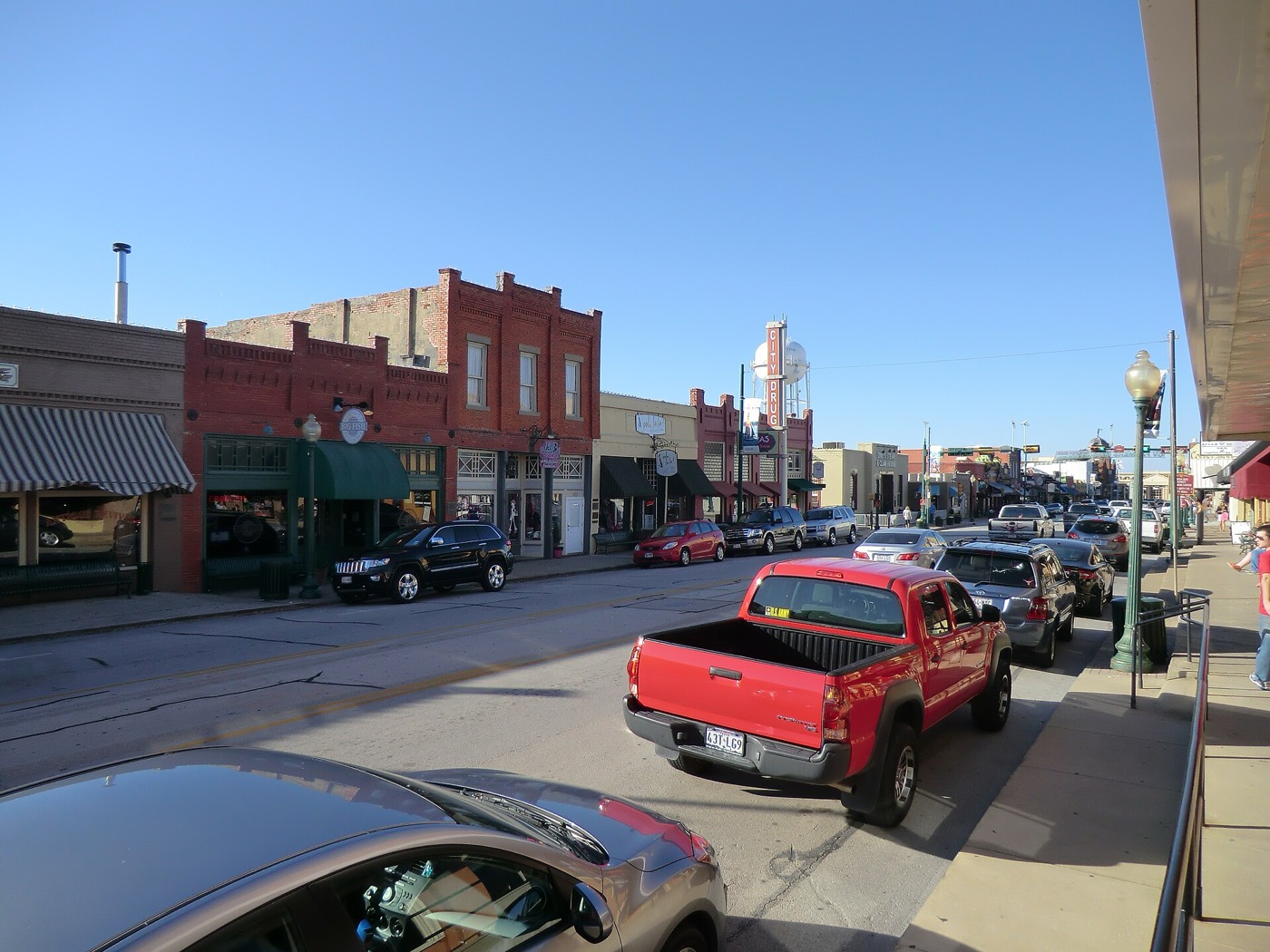 Historic brick storefronts and parked trucks along Main Street in Grapevine, Texas