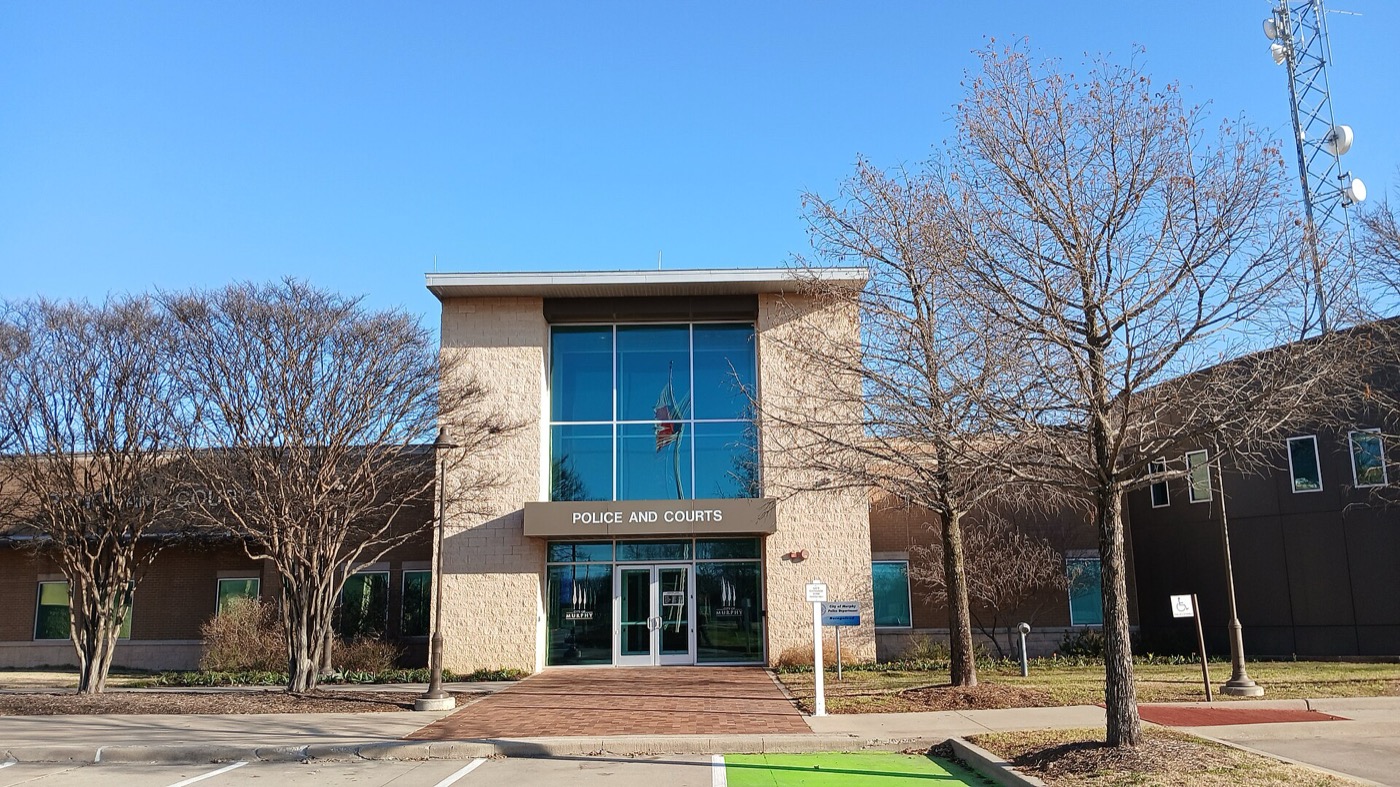 Modern Murphy Municipal Court and Police building with glass entrance and bare trees