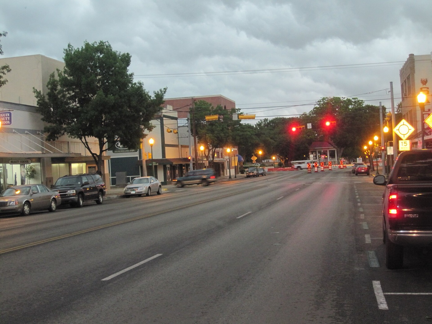 Downtown New Braunfels street with historic storefronts on a rainy morning