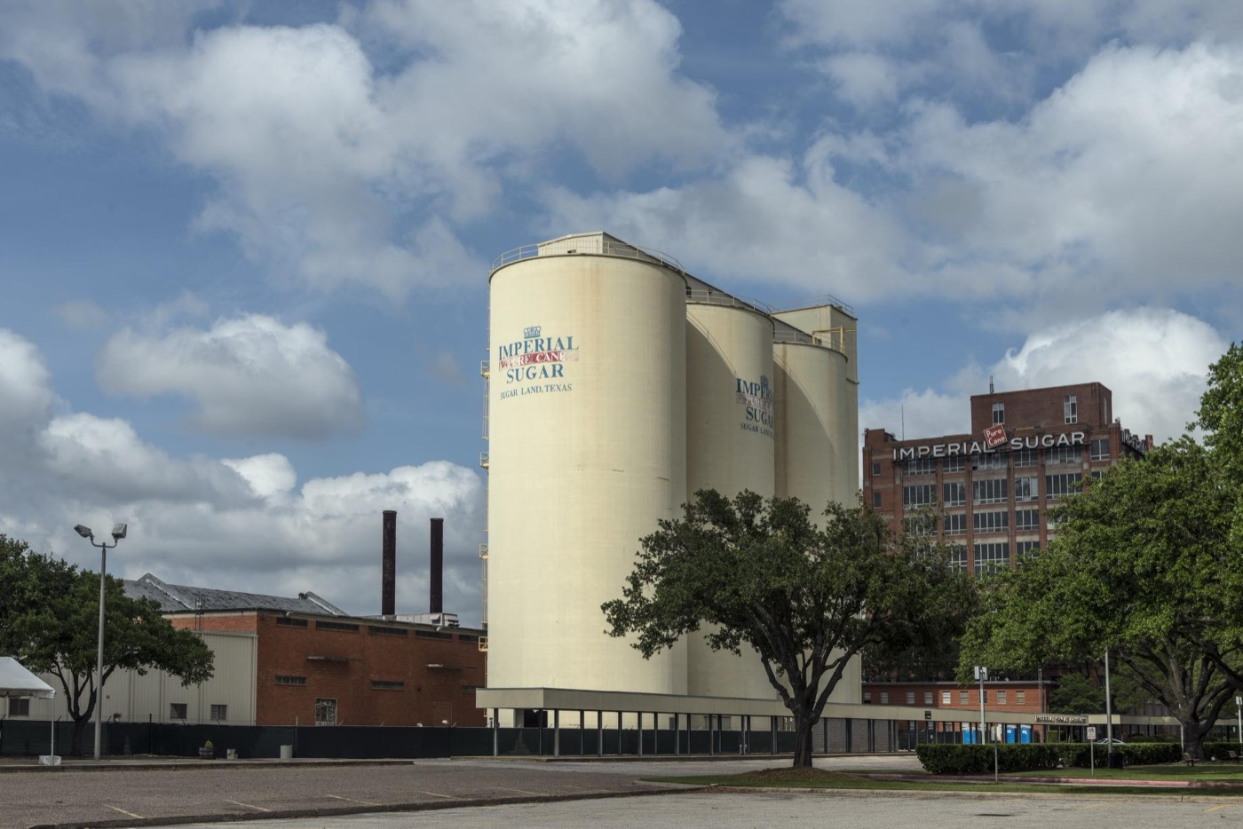 White silos and the brick Imperial Sugar building at the historic sugar refinery in Sugar Land