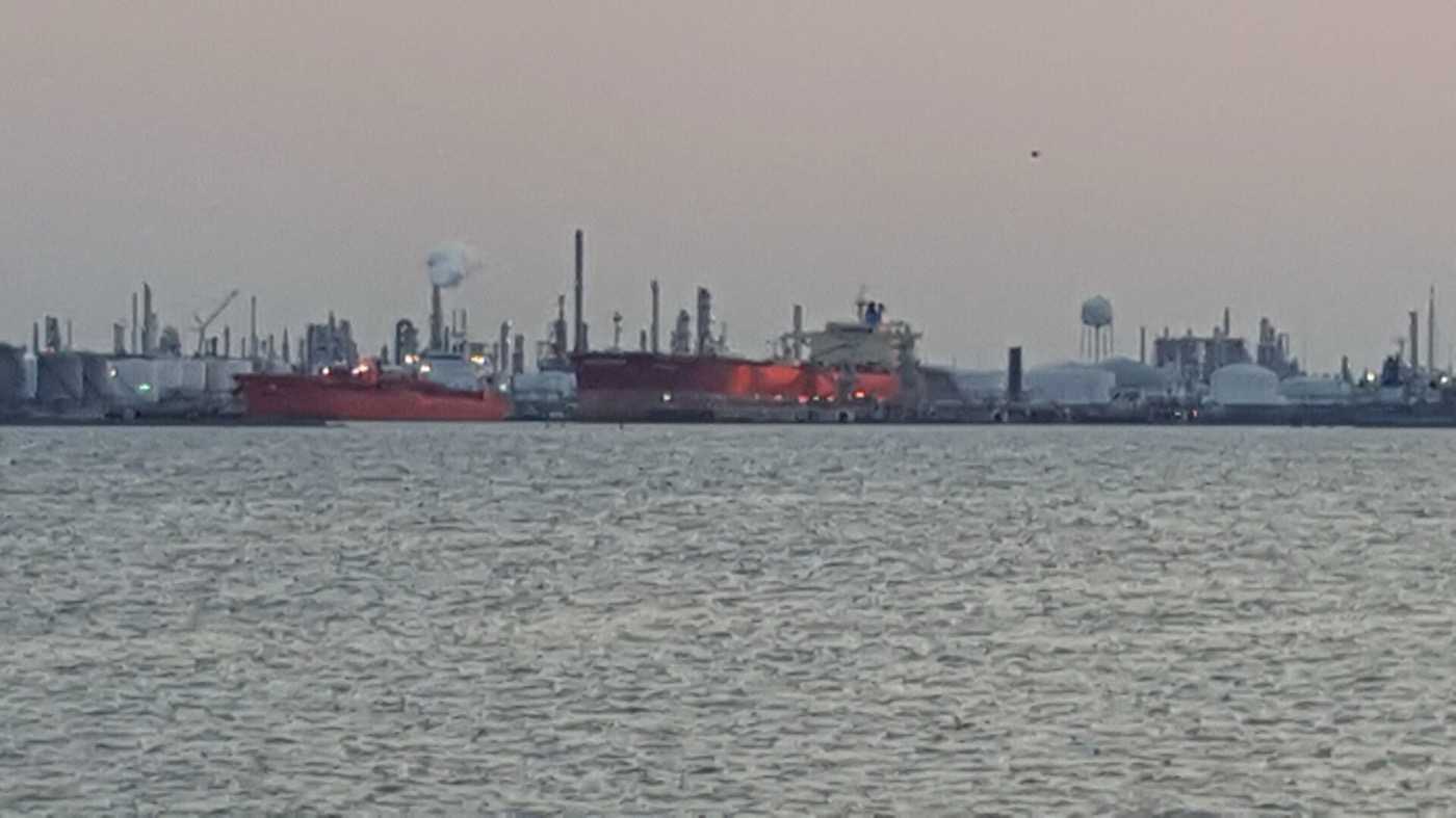Tankers docked along the Texas City industrial waterfront, seen across the bay from the Texas City Dike