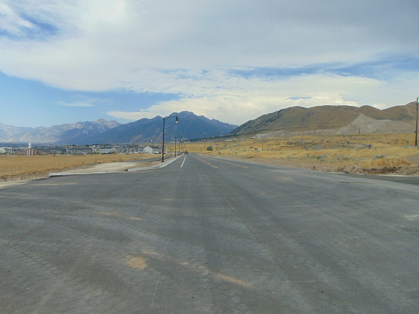 Porter Rockwell Boulevard in Bluffdale with the Wasatch Range and Traverse Mountains in the distance