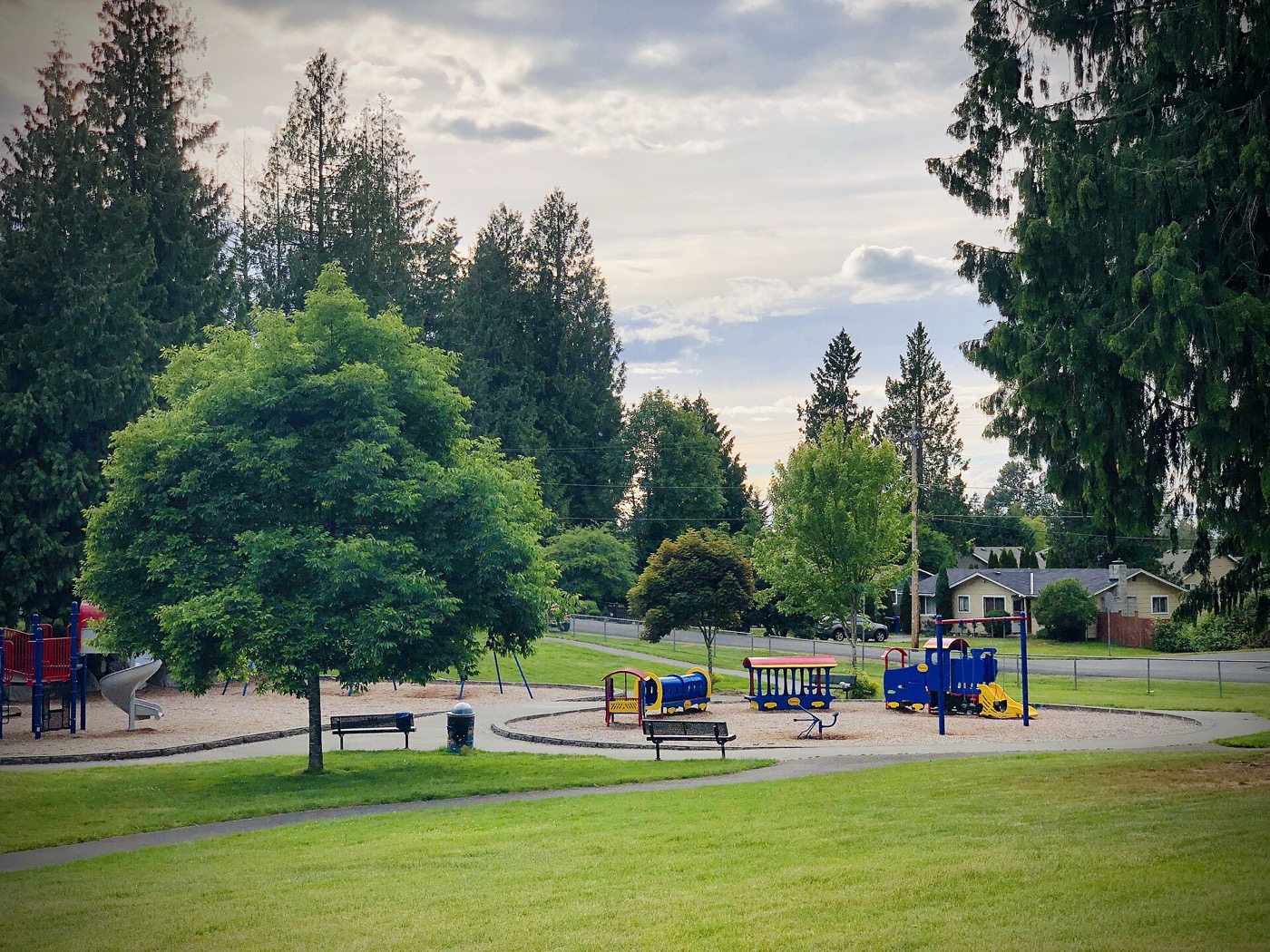 Playground, lawn and tall evergreens at Cedarview Park in Bonney Lake