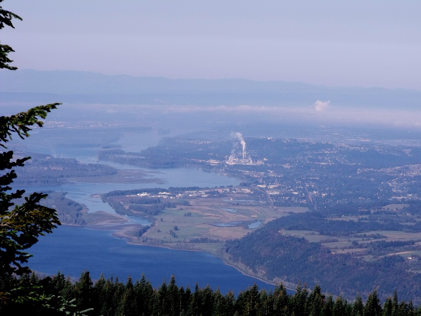 Wide aerial view of Camas, Washington, with the Columbia River and its paper mill in the distance