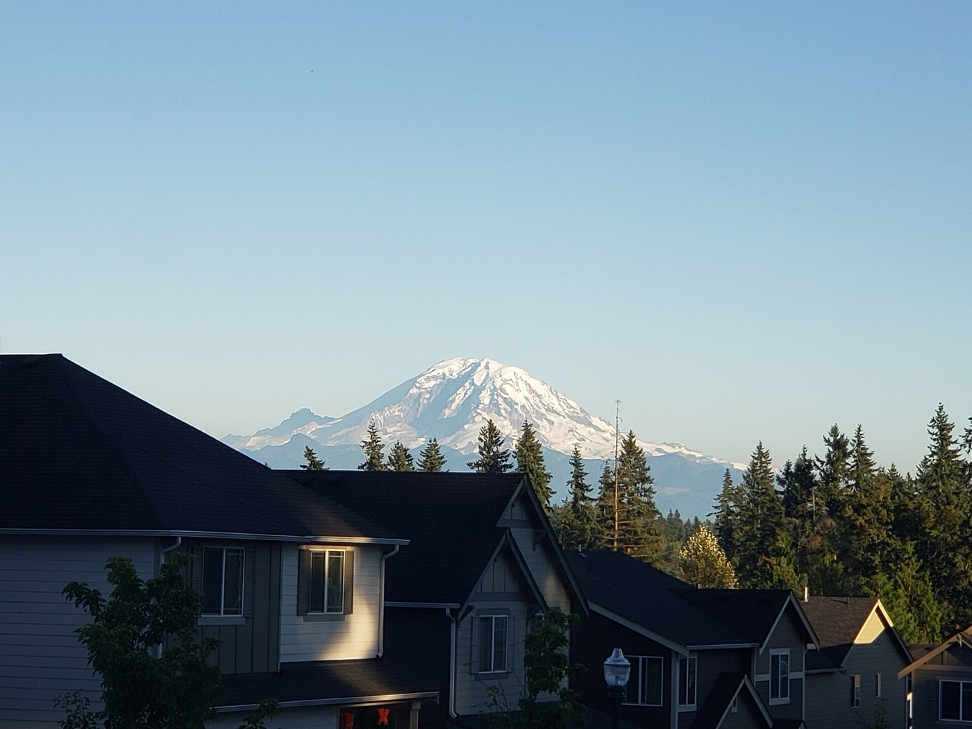 Mount Rainier rising beyond houses in a Covington residential neighborhood