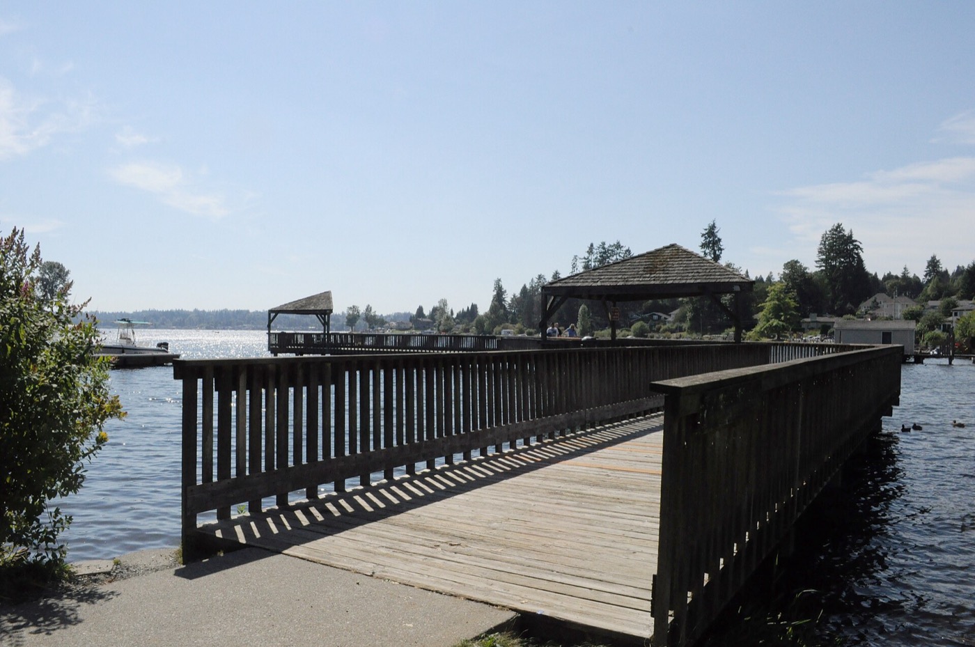 Wooden boardwalk pier at North Cove Park extending onto the lake in Lake Stevens, Washington
