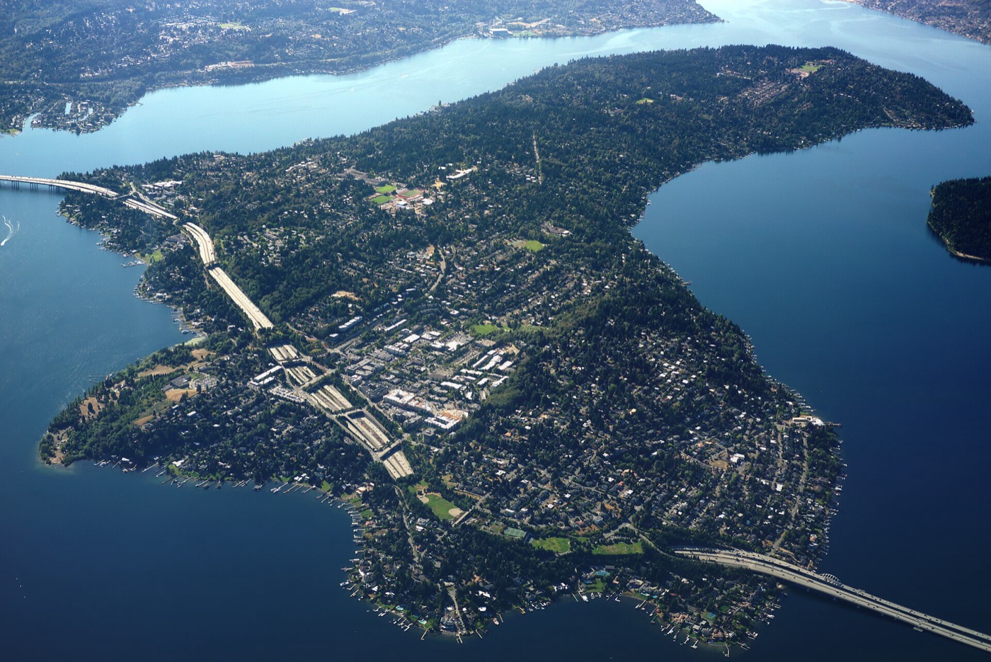 Aerial view of Mercer Island in Lake Washington with the I-90 floating bridges and wooded neighborhoods