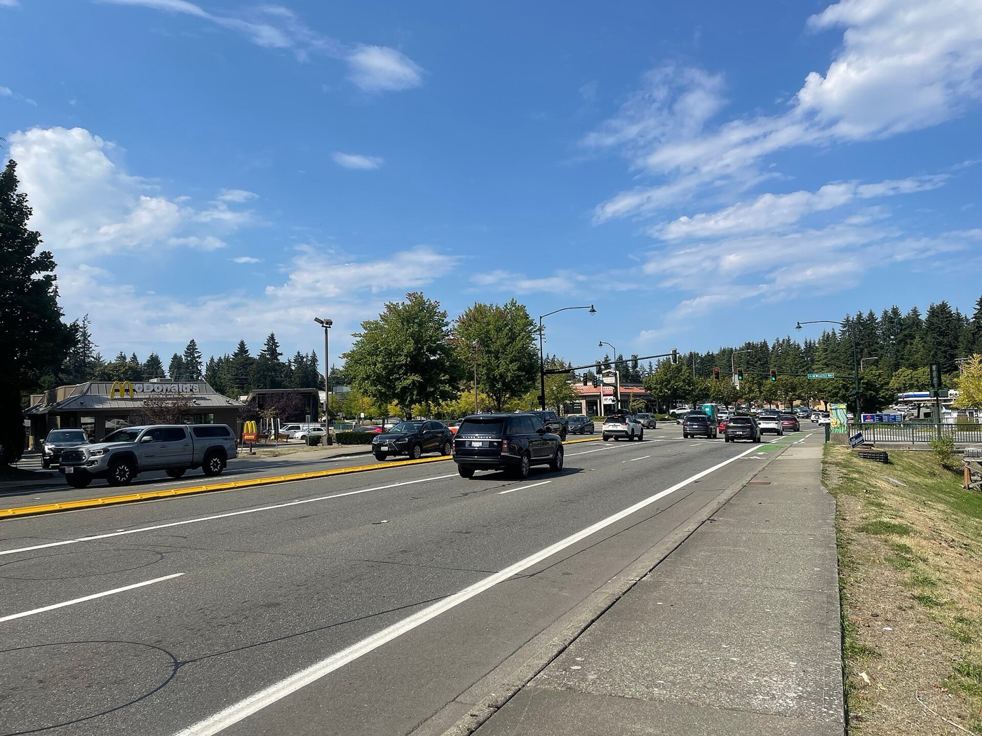 Busy intersection of Coal Creek Parkway and Newcastle Way with shops and the library