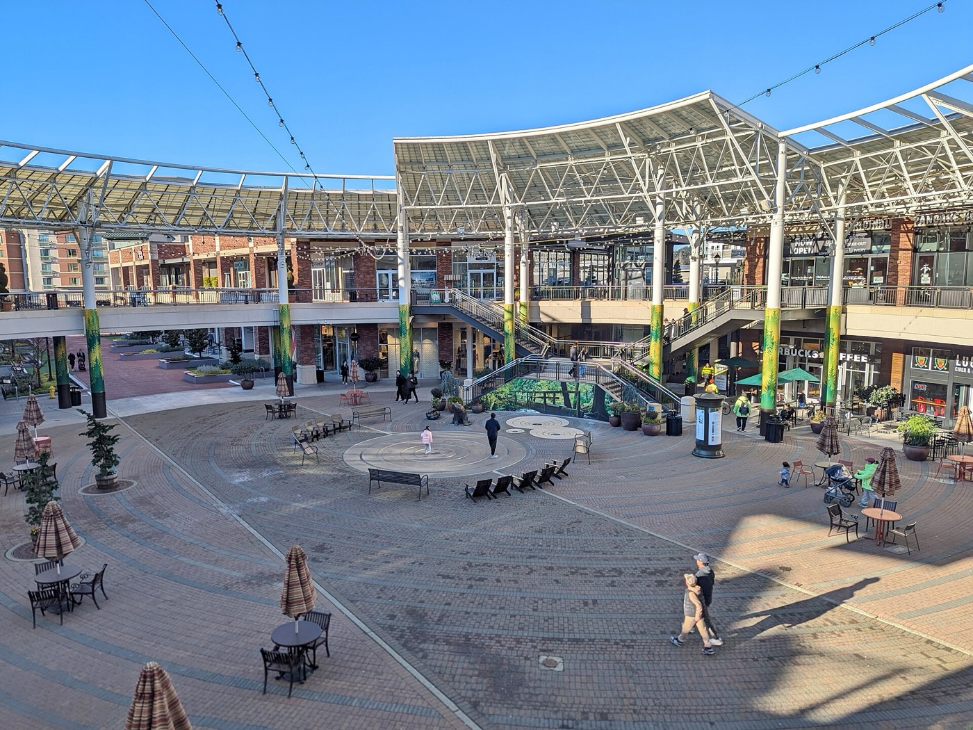 Open-air plaza with a curved canopy and shops at Redmond Town Center in Redmond, Washington
